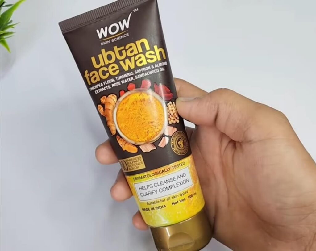 Reviewing Wow Ubtan Face wash in hands 